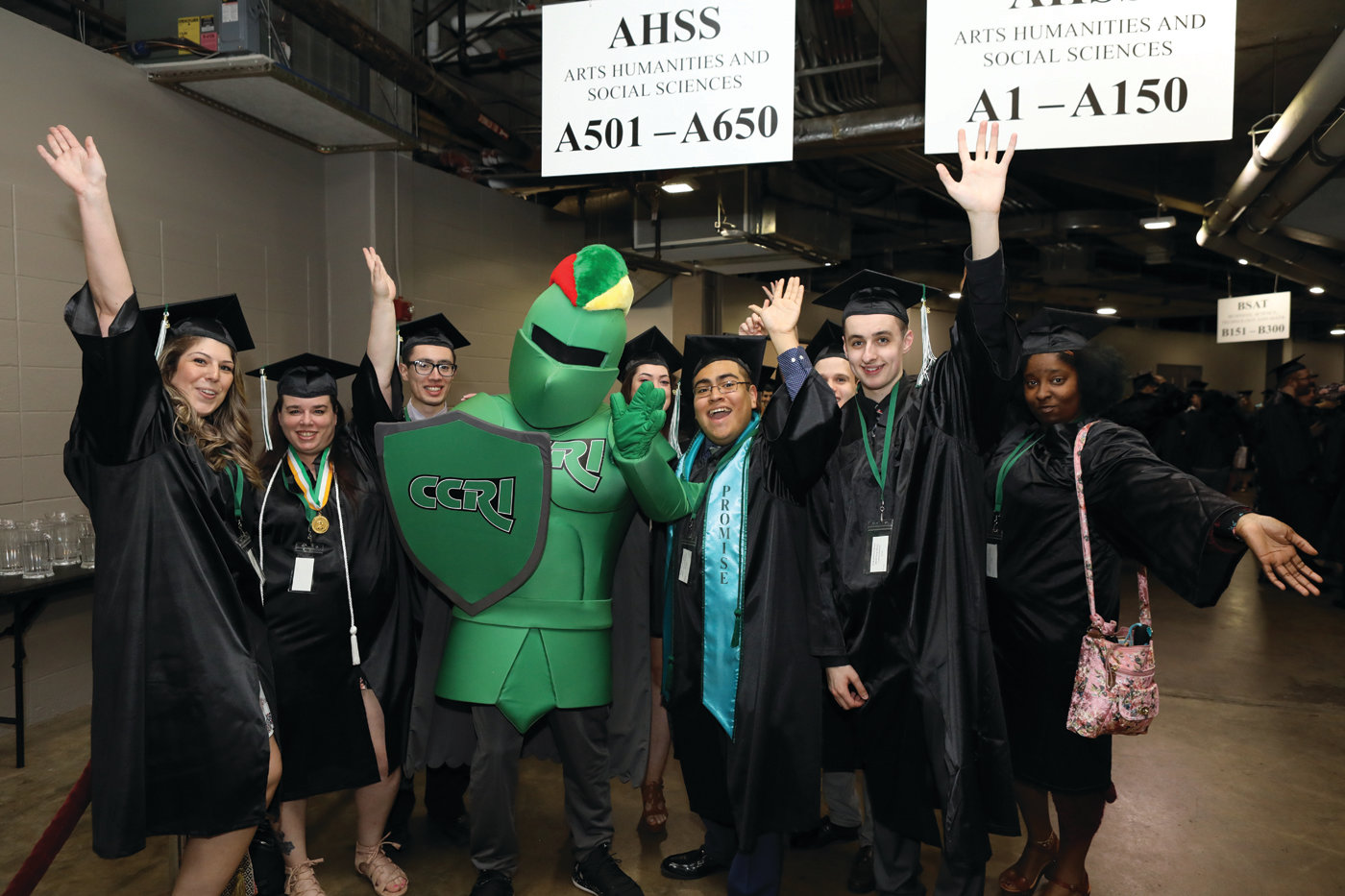 PROUD KNIGHTS: Members of CCRI’s graduating class share a moment with the school’s mascot ahead of the May 16 commencement ceremony at the Dunkin’ Donuts Center.